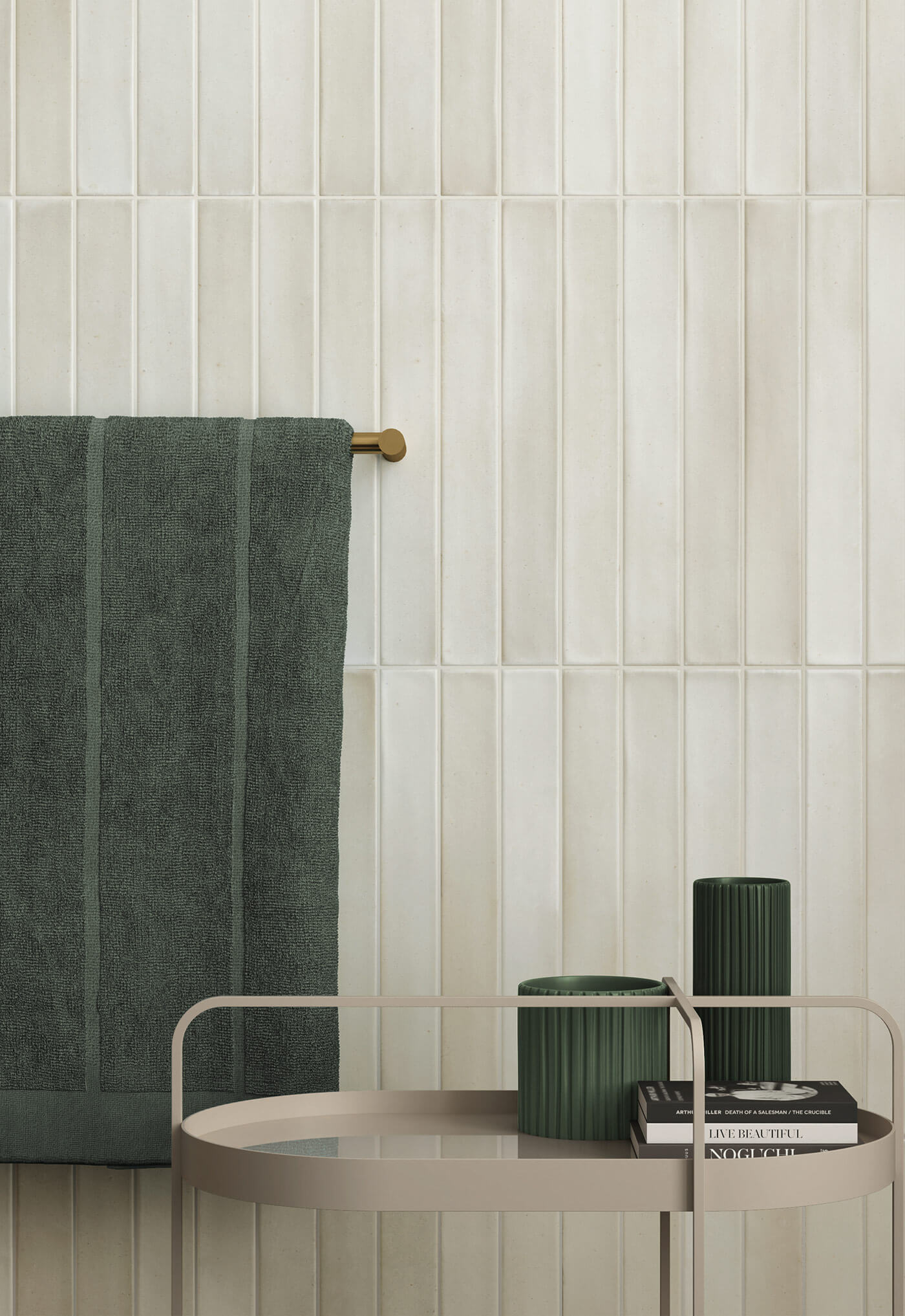 Close up of bathroom featuring light green subway tiles on the wall, green towel and candles.