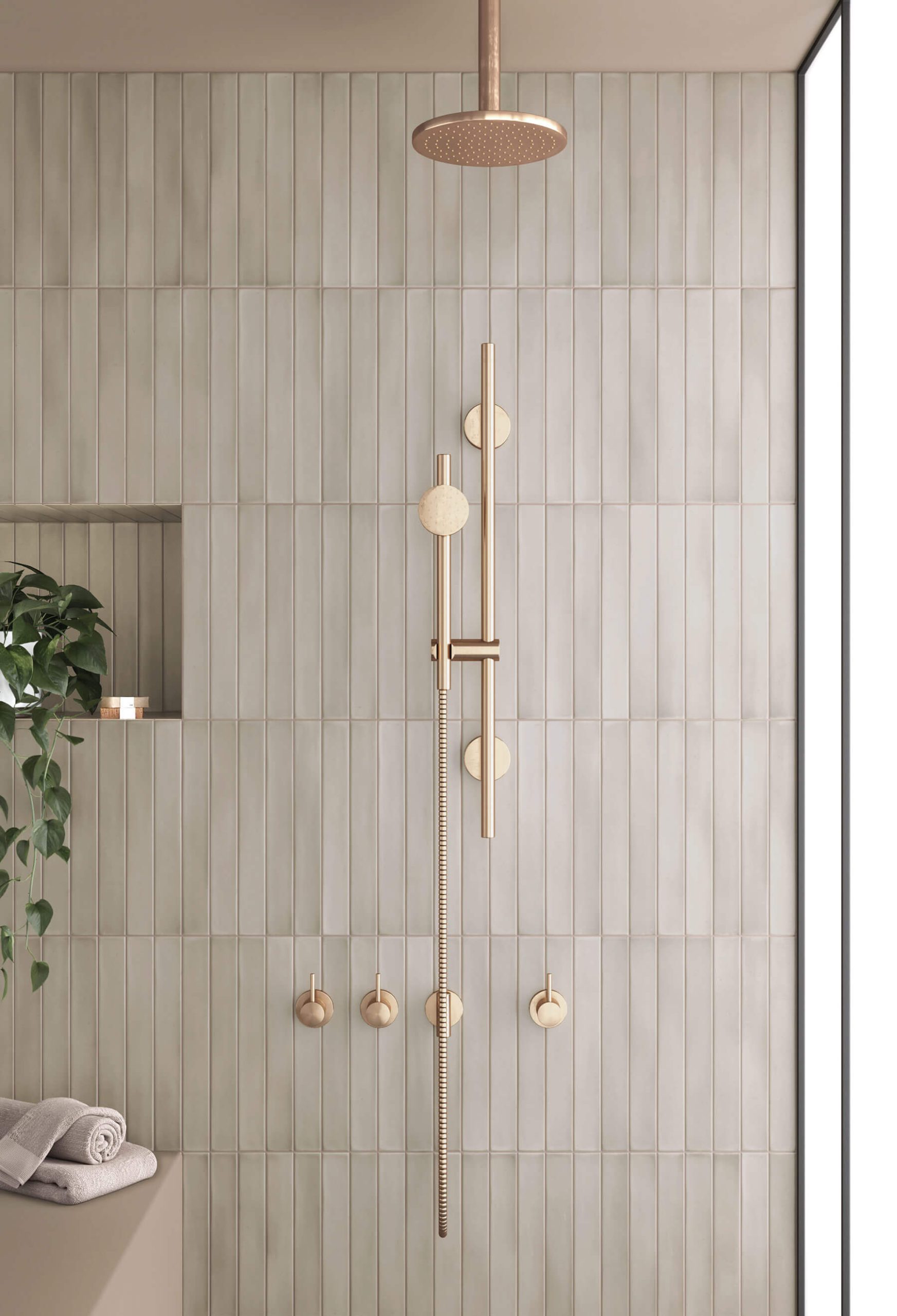 Peaceful feeling bathroom with tall thin subway tiles in soft cream colour as the wall, and stylish gold tapware.