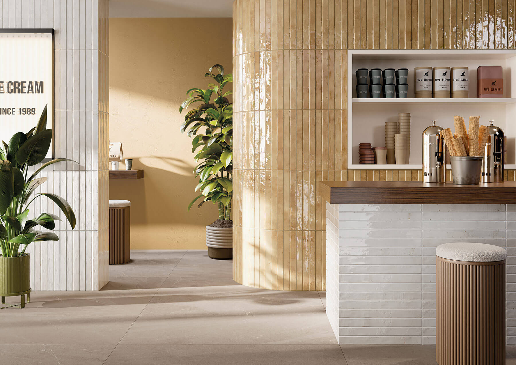 Cafe concept with honey colour glossy subway tiles laid vertically on a curved wall.