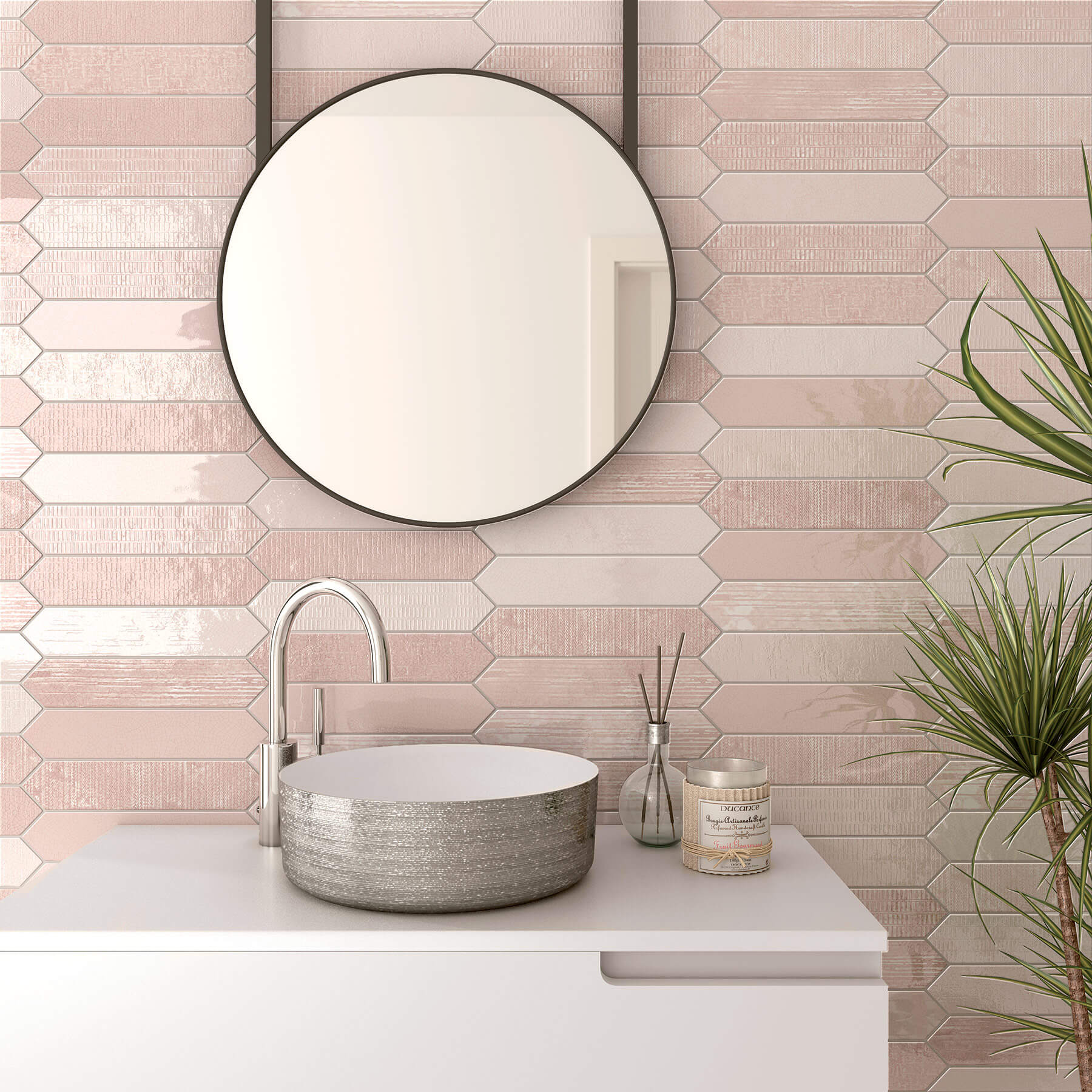 Close up of bathroom vanity with white cabinet, sliver vanity and tapware, circle mirror and soft pink tiles in a variety of finished and tones.