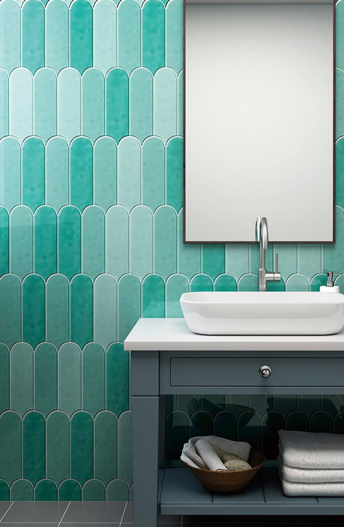 Close up of bathroom with feature wall of aqua colour tiles in various tones.