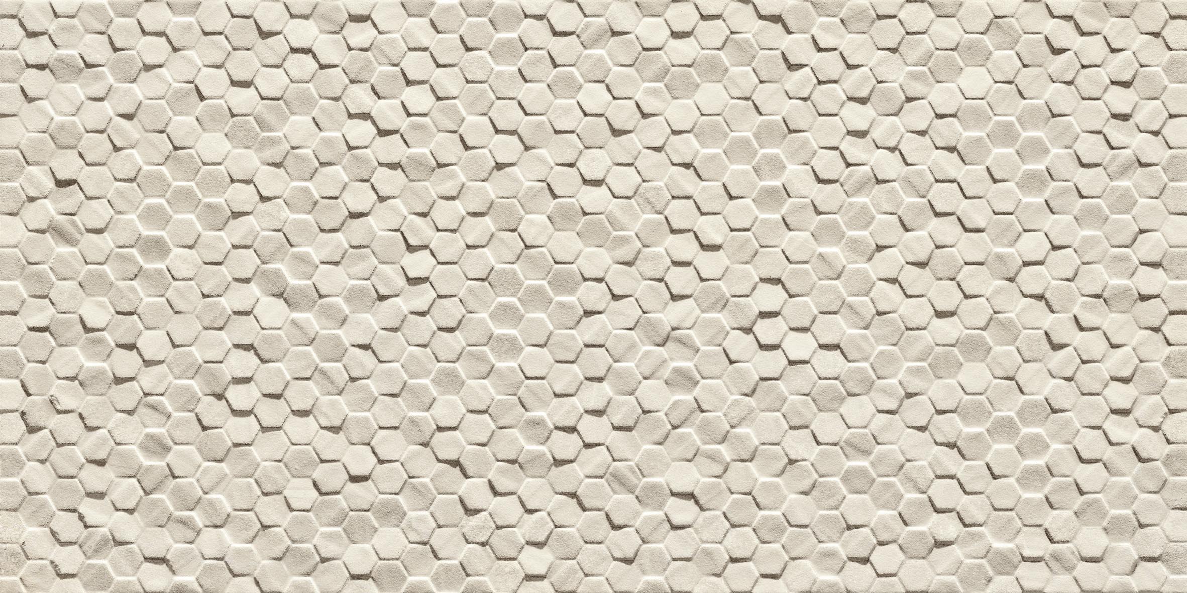 Close up of small hexagon mosaic tiles in cream. The surface of the tiles is not all level so it has created a honeycomb look.