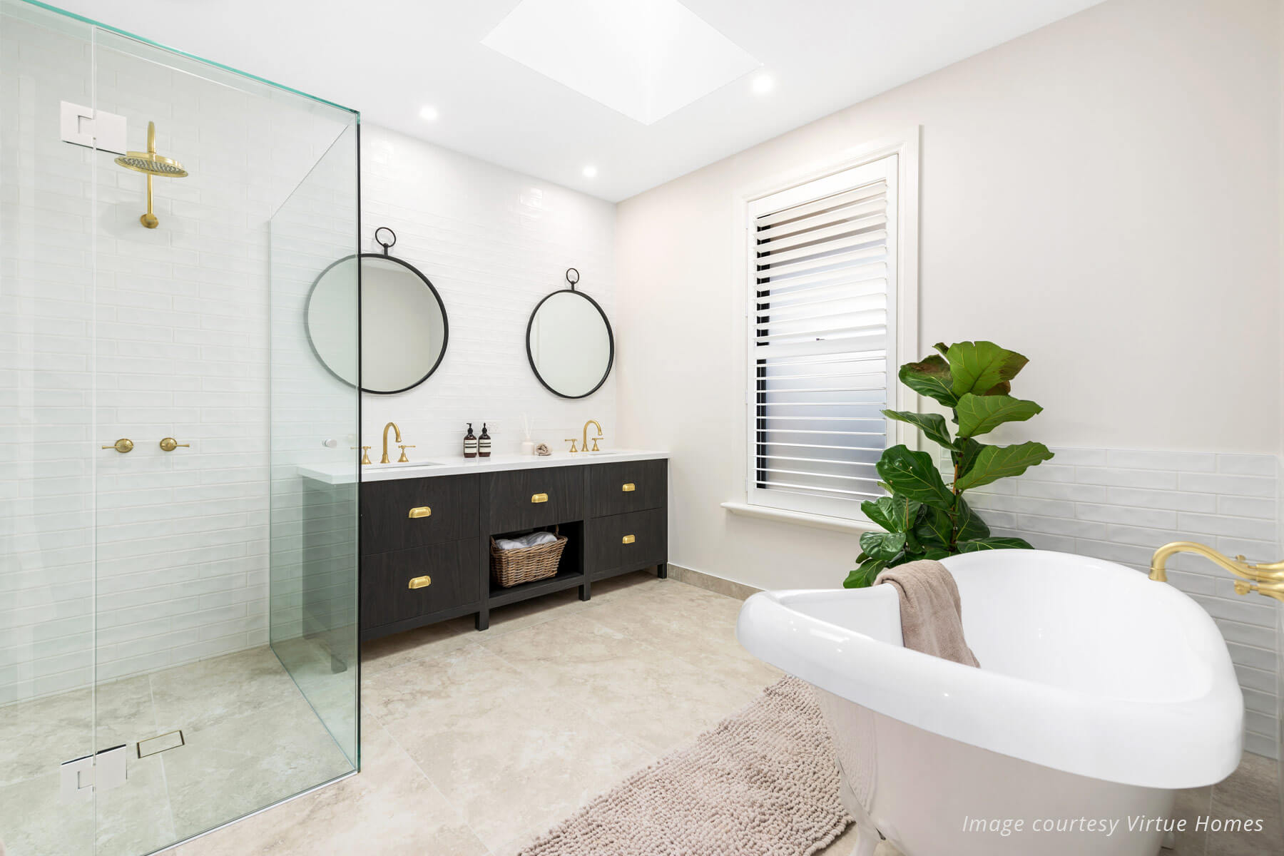 Luxury farmhouse style bathroom with white walls, white soaking tub, timer double vanity and large shower.