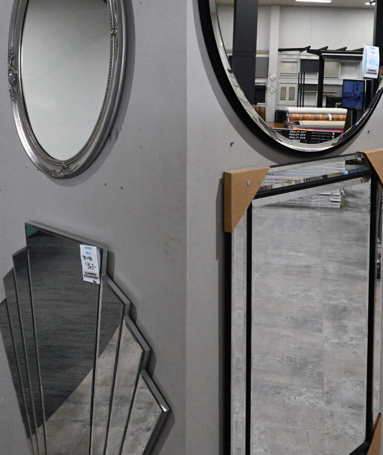 Selection of four mirrors on display with various frames and styles.