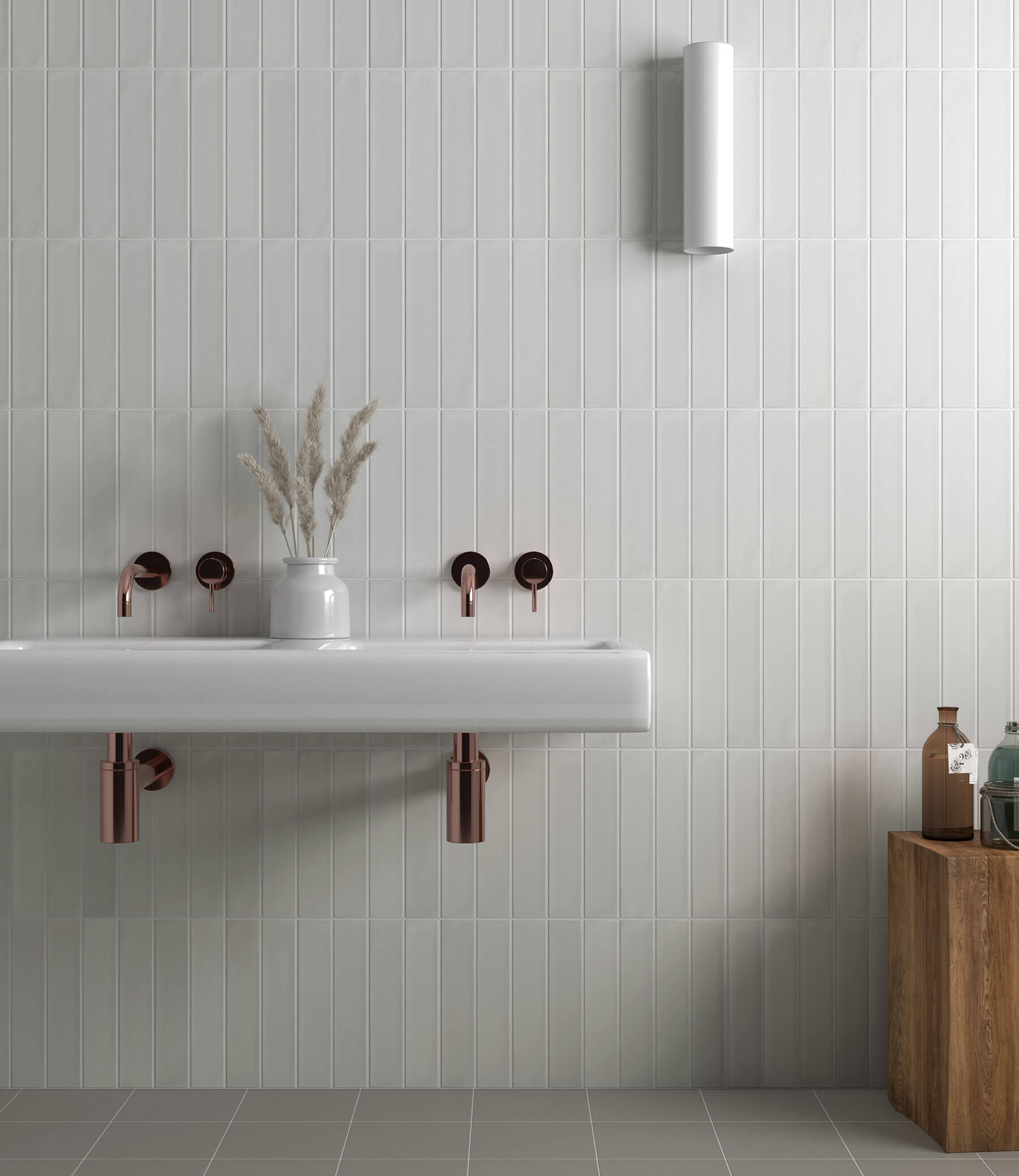 Looking at a bathroom wall with white subway tiles, simple white vanity sink that is also the bench, and sleek rose gold tapware.